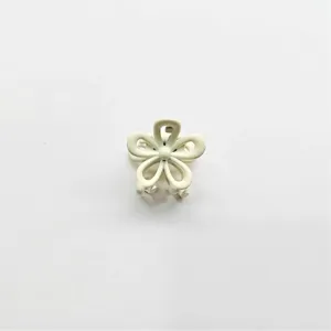 Mini alloy flower hair claw clip for women, cute floral hair accessory for styling.