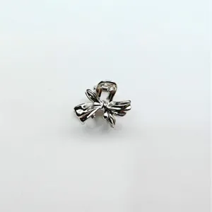 Silver alloy mini bow hair claw clip, cute styling accessory for bangs and broken hair.