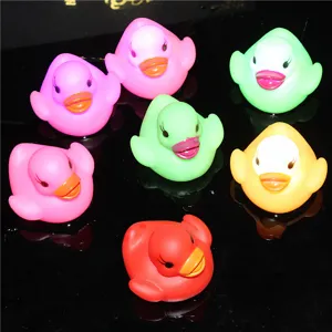Close-up detail shot of colorful glowing LED floating ducks designed for baby bath time play.
