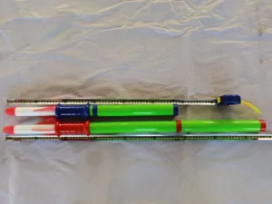 Hand push rocket launcher toy detail shot with measuring tape showing size and design.