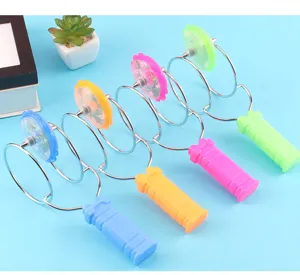 Detail view of colorful magnetic spinning gyro toy with glowing top and metal spiral handle.