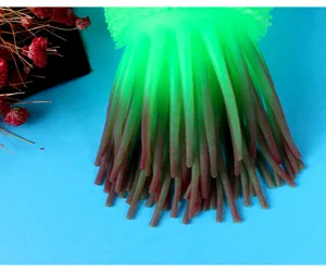 Close up of soft rubber glowing caterpillar sensory toy tentacle texture in vibrant colors.