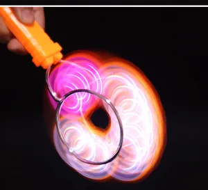 Close-up detail shot of the glowing magnetic spinning toy showing vibrant light trails in action.