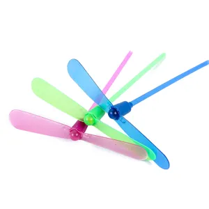 Detailed view of colorful plastic bamboo dragonfly flying toys with hand push spinning propeller.