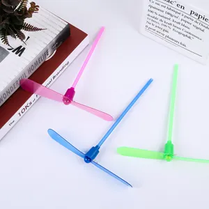 Close-up detail view of colorful luminous flashing bamboo dragonfly plastic flying toys.