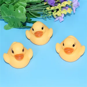 Close-up detail view of floating glowing yellow bath duck toy in water playing scene.