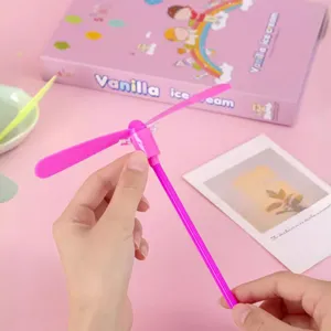Pink luminous bamboo dragonfly flying toy, flashing handheld rotary novelty toy for kids.
