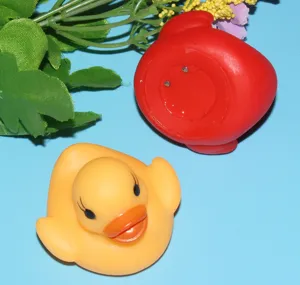 Close-up detail of glowing rubber duck bath toy with water sensor and bright LED lights.