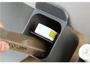Detail shot of a grey desktop storage box pen holder, wall-mounted sticky office organizer.