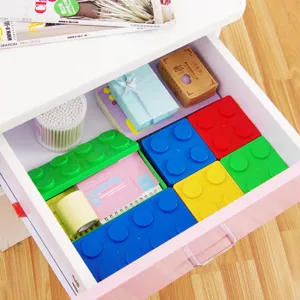 Stackable Lego shaped plastic storage box for desktop stationery and small items organization.