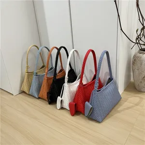 Chic woven shoulder bag detail showcasing multiple vibrant colors and exquisite braided texture design.