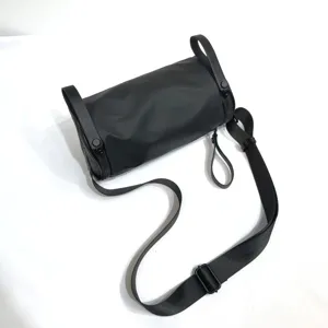 Black nylon barrel bag for daily wear, minimalist waterproof crossbody shoulder bag.