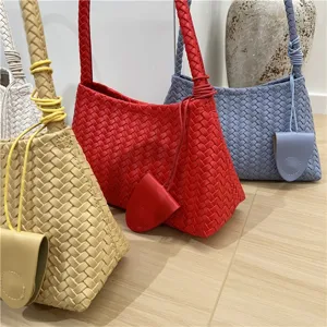 Detailed view of stylish woven leather shoulder bag with classic intrecciato design for women.