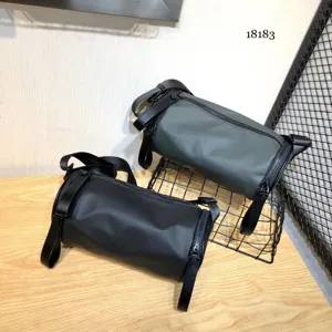 Water-resistant nylon cylinder crossbody bag, dark style shoulder bag for daily and student use.