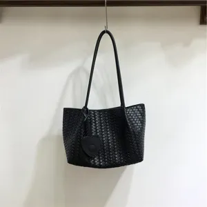 Black woven leather shoulder bag with cute heart charm, elegant underarm daily tote.