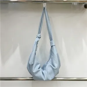 Detailed view of the soft leather pleated hobo bag showing texture and slouchy design.