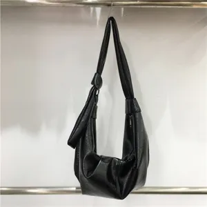 Black faux leather slouchy shoulder bag, casual hobo dumpling bag with knot detail.