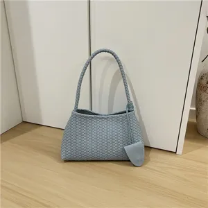 Light blue woven shoulder bag, elegant intrecciato design, chic underarm baguette purse.