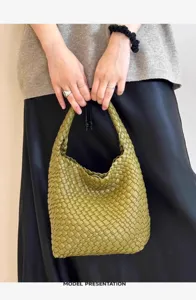Detailed view of woven leather handbag, premium intrecciato texture, elegant daily shoulder bag.
