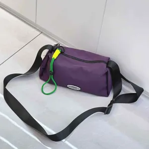 Lightweight women crossbody bag detail view, casual nylon shoulder bag with green cord.