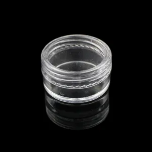 Detailed view of a clear plastic cosmetic sample jar with flat cap, ideal for glitter storage.