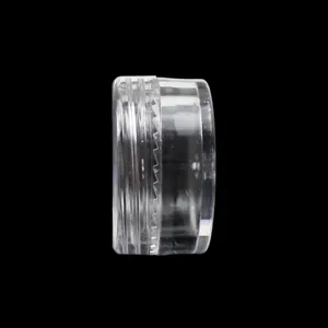 Close-up detail shot of a transparent plastic cosmetic sample jar, showing side profile and lid.