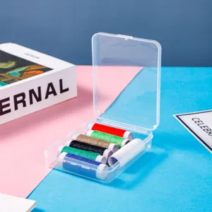 Transparent plastic storage box container with colorful thread spools for organizing small items.