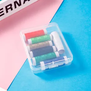 Portable transparent plastic storage box with colorful sewing thread spools inside.
