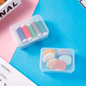 Clear plastic storage box detail showing neat compartments with colorful sewing threads inside.