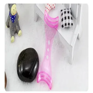 Pink plastic eyelash shield makeup tool helper for easy mascara application detail shot.
