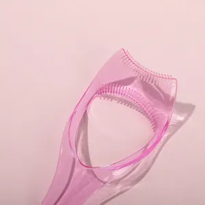 Pink plastic eyelash guard tool, makeup shield and comb for easy mascara and eye shadow.