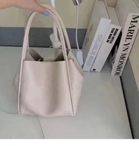 Minimalist beige PU leather bucket handbag, stylish large capacity tote bag for daily use.