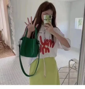 Green leather bucket bag for women, large capacity casual handbag with shoulder strap.
