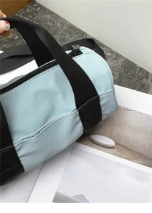 Lightweight oxford cylinder shoulder bag, casual commuting sport crossbody design detail.
