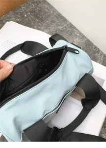 Detail view of the casual cylindrical shoulder bag interior zipper pocket and oxford fabric.