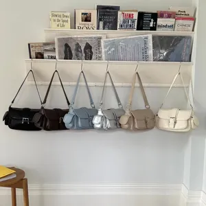 Retro minimalist women's shoulder bag with chic flap closure and stylish side pockets.