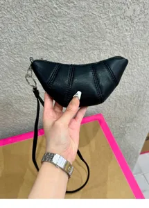 Small black leather crescent coin purse croissant shoulder bag with lanyard daily.