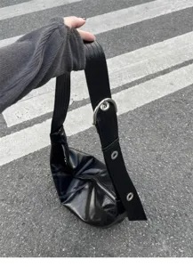 Detailed shot of black soft leather hobo shoulder bag with wide strap and metal buckle.