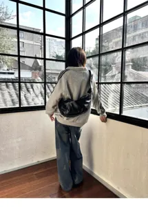 Retro soft leather crossbody bag detail, vintage dumpling purse style, wide strap fashion view.