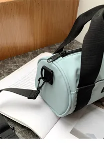 Light blue casual cylindrical shoulder bag detail, stylish daily commute oxford cloth crossbody.