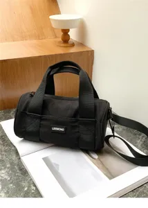 Black oxford cloth cylindrical shoulder bag detail, casual daily crossbody design.