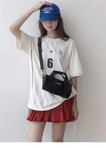 Compact black oxford cylindrical shoulder bag detail, lightweight casual commuting style.