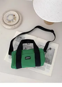 Green cylindrical nylon shoulder bag detail view with black handles and brand patch.