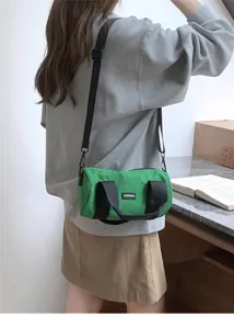 Green canvas cylindrical shoulder bag, casual crossbody duffel bag for women daily commute.