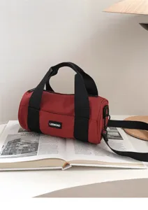 Red canvas barrel bag casual sports shoulder bag detail view with black strap and handle.