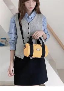 Casual yellow cylindrical oxford cloth shoulder bag detail shot, versatile everyday style.