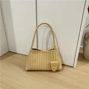 Chic woven shoulder bag for women, stylish underarm baguette handbag with elegant handle.