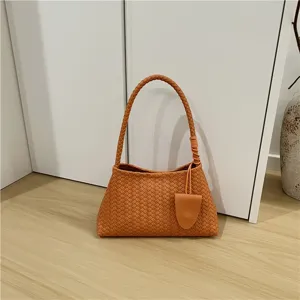 Detail view of the elegant woven shoulder bag, featuring a chic baguette design for women.