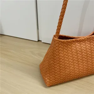 Brown woven leather shoulder bag detail close up, stylish chic underarm baguette handbag
