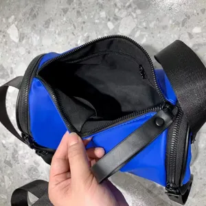 Stylish blue cylinder crossbody bag, water-resistant nylon shoulder bag for everyday use.